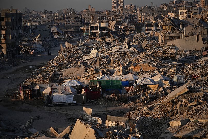 Tents for displaced Palestinians stand amid the destruction caused by the Israeli air and ground offensive in Gaza City, 22 October, 2025