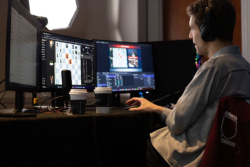 This undated photo released by Charlotte Chess Centre shows Daniel Naroditsky playing chess on a computer