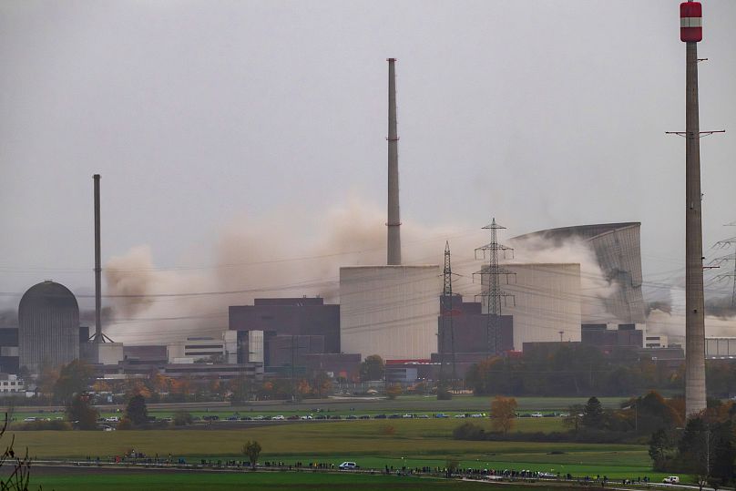 The two cooling towers of the decommissioned Gundremmingen nuclear power plant collapse during their demolition, in Gundremmingen, Germany, Saturday, Oct. 25, 2025.