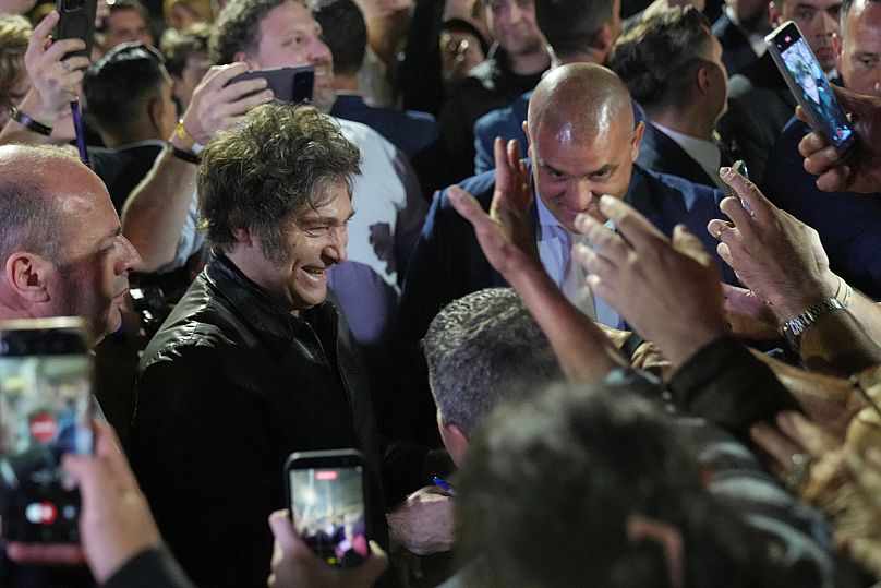 Argentina's President Javier Milei smiles to supporters after winning in legislative midterm elections in Buenos Aires, Argentina, Sunday, Oct. 26, 2025. (AP Photo/Rodrigo Abd