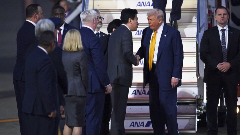 Trump is welcomed by Japan's newly appointed Chief Cabinet Secretary Minoru Kihara upon arrival at Haneda Tokyo International Airport in Tokyo, Japan, Monday, Oct. 27, 202