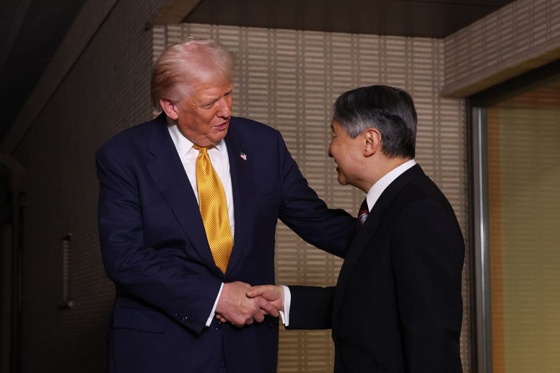 President Donald Trump, left, and Japan's Emperor Naruhito shake hands during their meeting at the Imperial Palace in Tokyo, Oct. 27, 2025