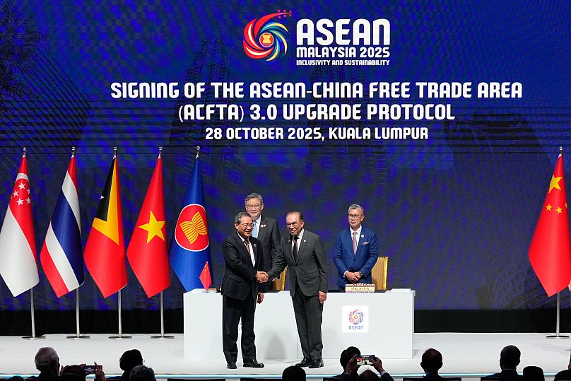 China's Premier Li Qiang, front left and Malaysia's Prime Minister Anwar Ibrahim, front right, shake hands after witnessing the signing ceremony for ASEAN-China Free Trade.