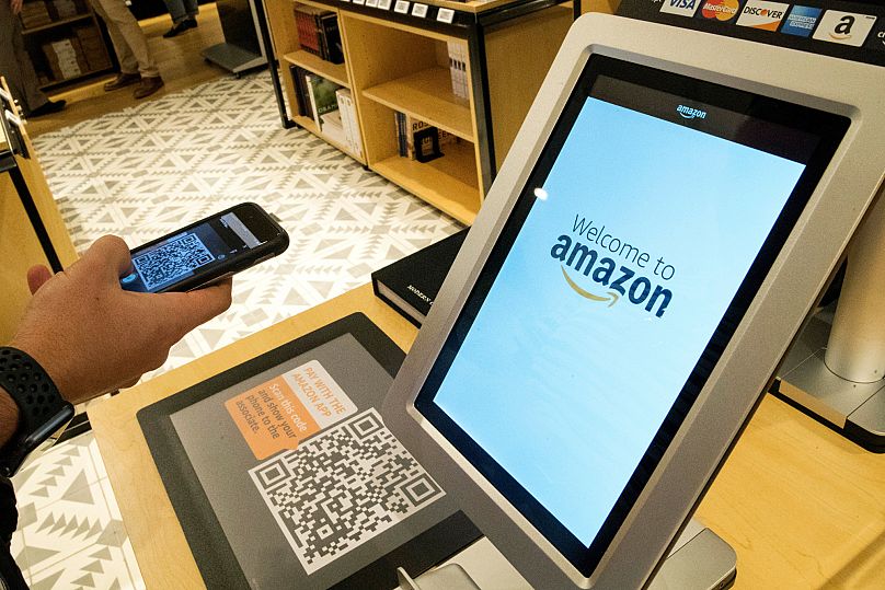 A man uses the Amazon app to pay for his purchase at the Amazon 4-star store in the Soho neighbourhood of New York, 27 September, 2018