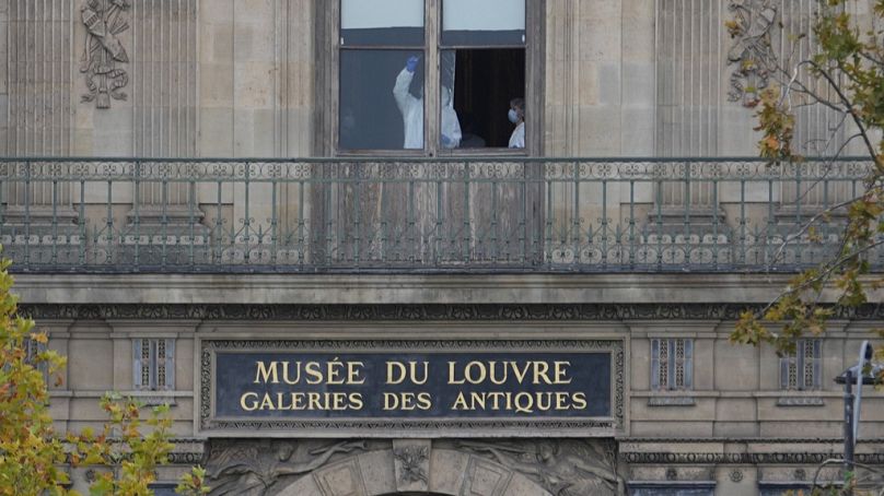 Police officers work inside the Louvre museum, Sunday, Oct. 19, 2025 in Paris, France.