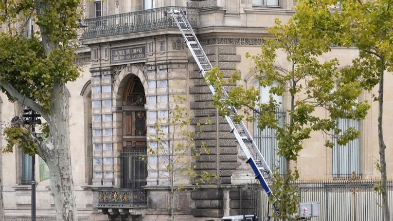 Police officers work by a basket lift used by thieves Sunday, Oct. 19, 2025 at the Louvre museum in Paris, France.