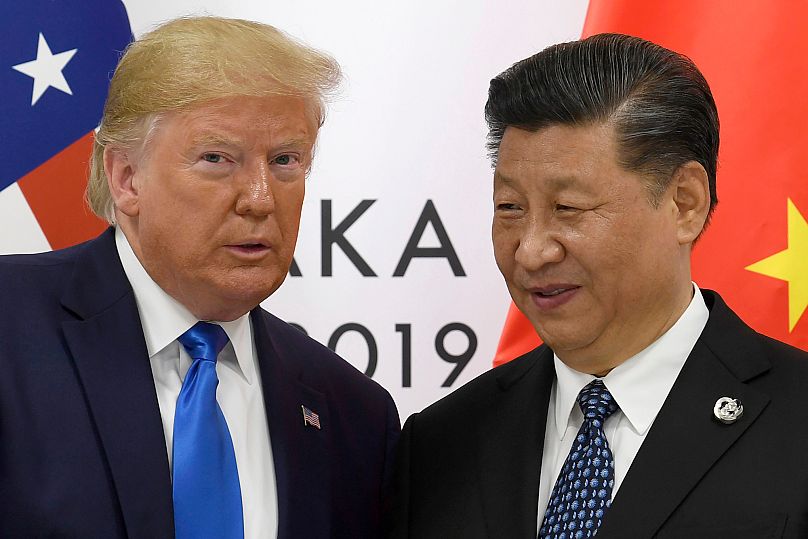 FILE - President Donald Trump poses for a photo with Chinese President Xi Jinping during a meeting on the sidelines of the G-20 summit in Osaka, western Japan, on June 29 2019