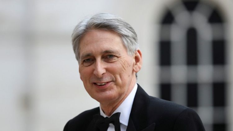 UK borrowing falls more than expected, Hammond under pressure to spend
