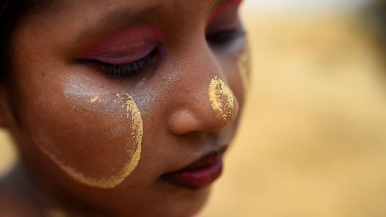Wearing tradition, thanaka paste in a Rohingya camp