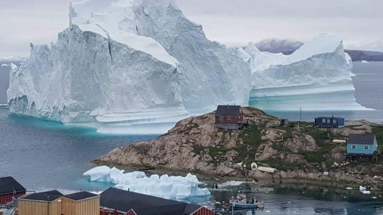 Huge iceberg drifts close to Greenland village, causing fears of a tsunami