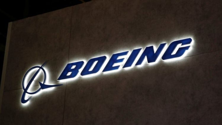 Boeing to incur charge related to sale of production facilities