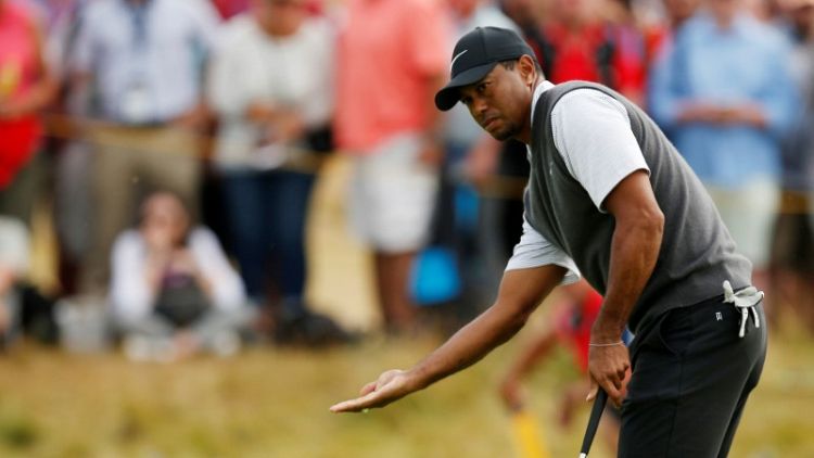 Golf: Charging Woods grabs share of lead at Carnoustie