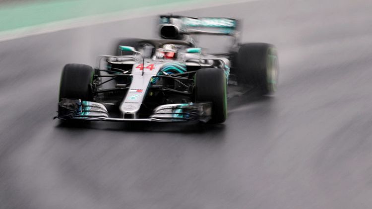 Hamilton beats the elements to seize pole in wet Hungary