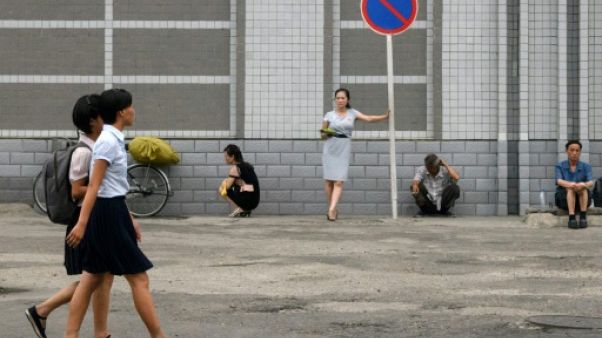 Des piétons dans une rue de Pyongyang, le 25 juillet 2018 en Corée du Nord Des piétons dans une rue de Pyongyang, le 25 juillet 2018 en Corée du Nord