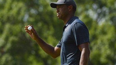 Golf - Woods recovers from poor start to grind out a score
