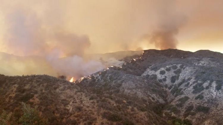 Aggressive wildfire threatens thousands of homes in southern California city
