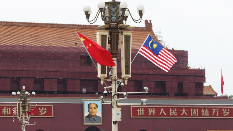 China, Malaysia sign MOU on bilateral currency swap agreement - Reuters witness