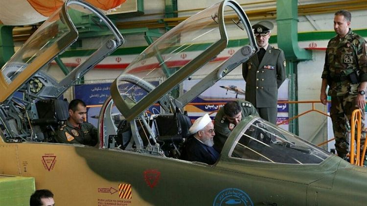 Eying U.S., Iran says to boost military might, showcases new fighter jet