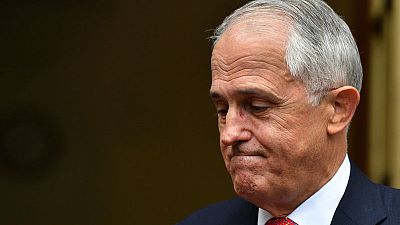 Australian PM, fighting for political life, dumps tax policy