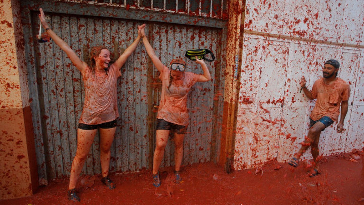 People in red - thousands hurl tomatoes in Spanish food fight
