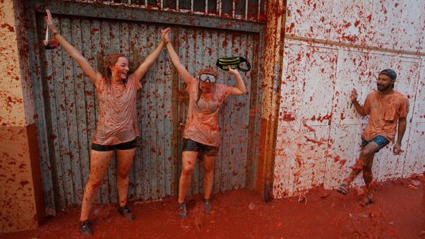 People in red - thousands hurl tomatoes in Spanish food fight People in red - thousands hurl tomatoes in Spanish food fight