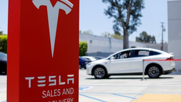 Tesla bond hits record low, stock slips as investor worry deepens