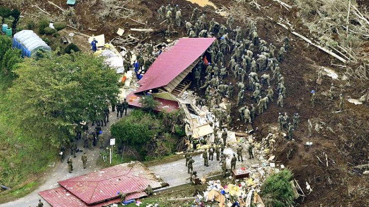 Rescuers with dogs search for survivors after deadly Hokkaido quake