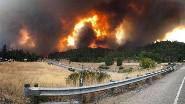 Northern California wildfire threatens homes, closes major highway
