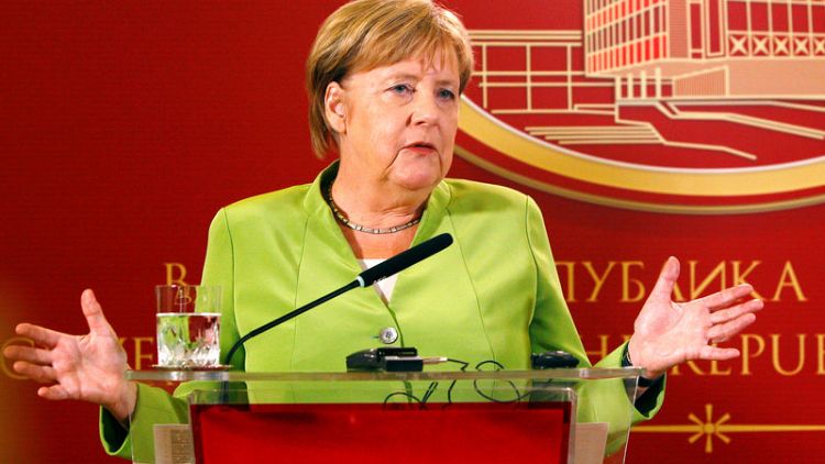 Merkel targets debt reduction, investment as tax take "very good"