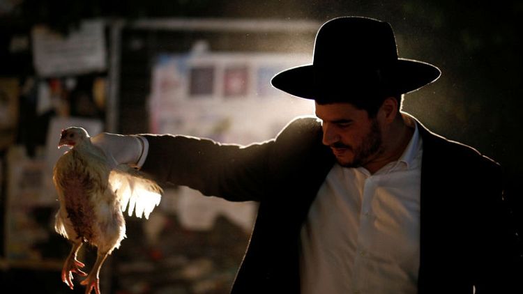 Ahead of Yom Kippur, ultra-Orthodox Jews cast out sins with chickens and water