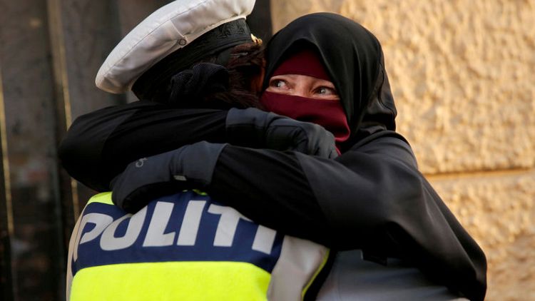 Danish police investigate officer who hugged niqab-wearing protester