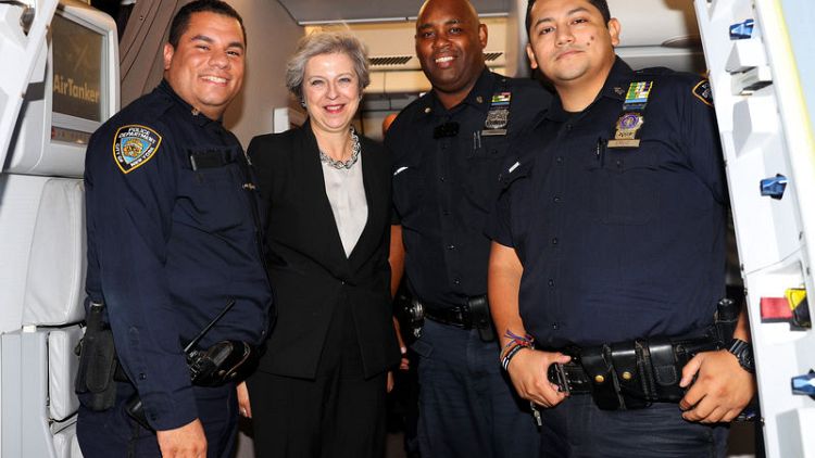 An Englishwoman in New York -  May poses with police to help stranded aides