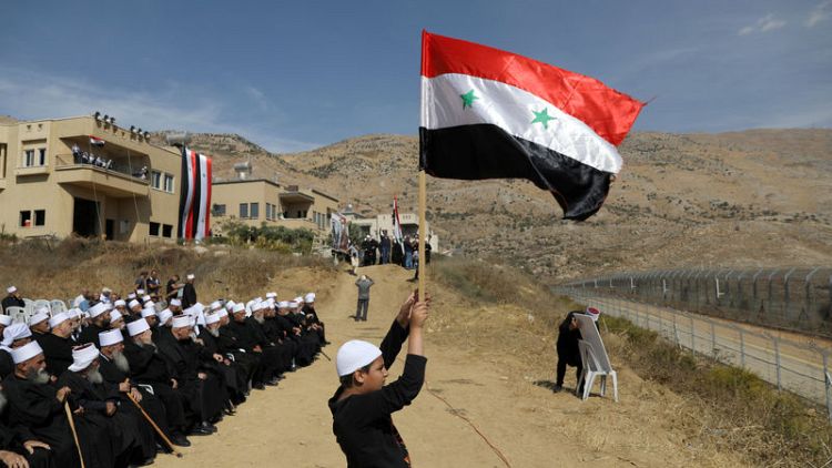 Golan Druze gather at border, chanting loyalty to Syria's Assad