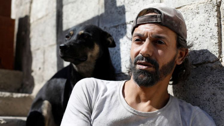 In Syria's Yarmouk, a pigeon keeper and his dog held out through years of war