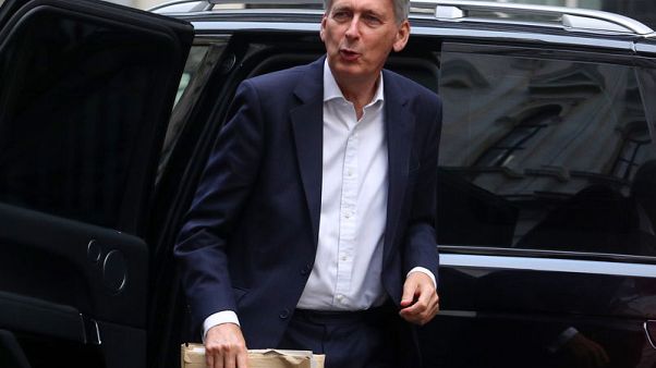 UK posts smaller-than-expected budget deficit in boost for Hammond UK posts smaller-than-expected budget deficit in boost for Hammond