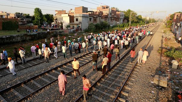 Indian officials exchange blame for train ploughing into festival crowd Indian officials exchange blame for train ploughing into festival crowd