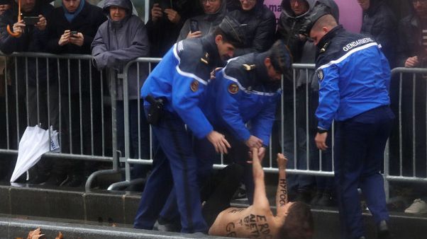 Topless female protester runs at Trump's motorcade in Paris Topless female protester runs at Trump's motorcade in Paris