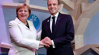 Macron, Merkel defend multilaterism as Trump avoids peace forum