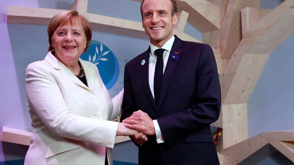 Macron, Merkel defend multilaterism as Trump avoids peace forum Macron, Merkel defend multilaterism as Trump avoids peace forum