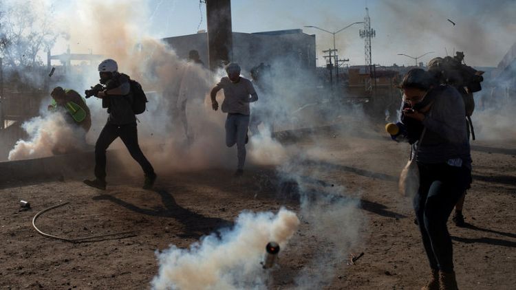U.S. fires tear gas into Mexico to repel migrants, closes border gate