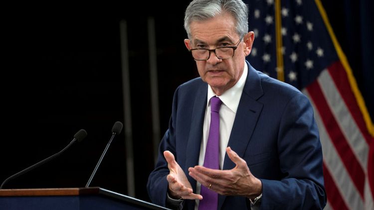 Fed's Powell, in dovish shift, says rates near neutral