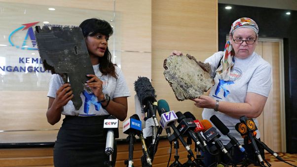Kin of missing from Malaysian plane hand over suspected debris, urge search Kin of missing from Malaysian plane hand over suspected debris, urge search