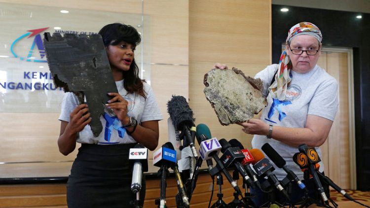 Kin of missing from Malaysian plane hand over suspected debris, urge search