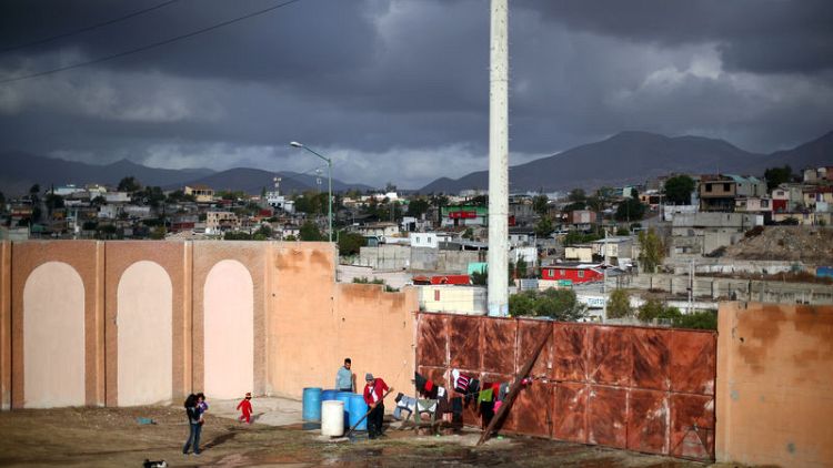 Caravan migrants in Mexico fill new border shelter after rains force exodus