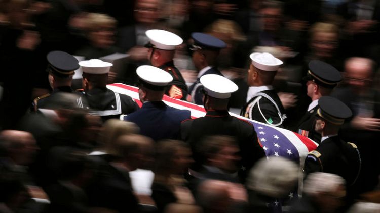 Master of bygone civility, Bush is hailed at funeral as U.S. 'soldier-statesman'