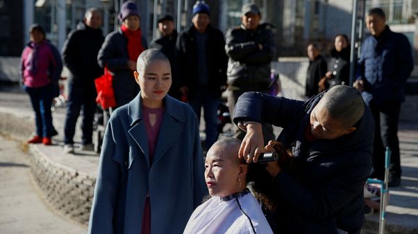 Four Chinese activists shave heads to protest 'persecution' of husbands Four Chinese activists shave heads to protest 'persecution' of husbands