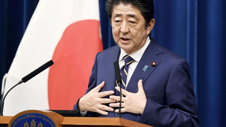 Japan's Cabinet approves record $900 billion budget, aims to soften sale tax blow