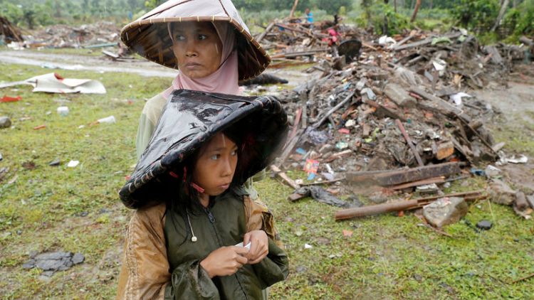 Indonesian rescuers struggle against heavy rain to reach tsunami-hit villages