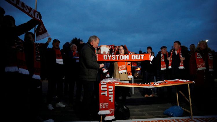 Blackpool fan protests on roof of Arsenal team bus
