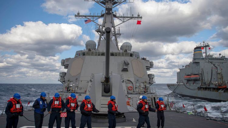 U.S. destroyer sails in disputed South China Sea amid trade talks
